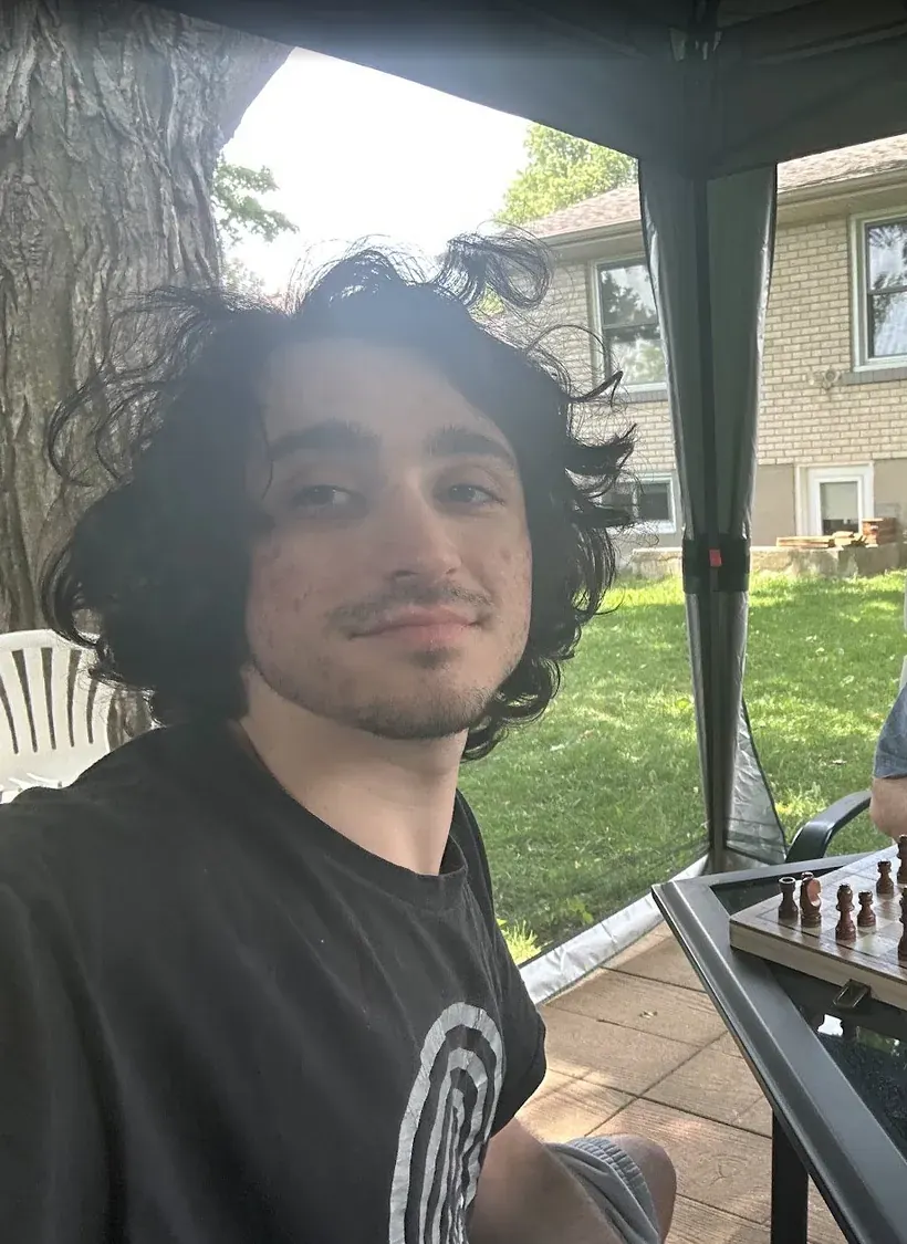 mel playing chess in a yard