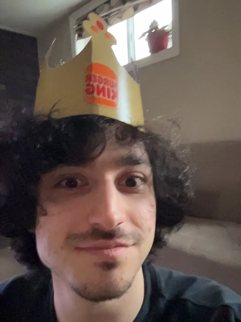 mel wearing a burger king paper crown
